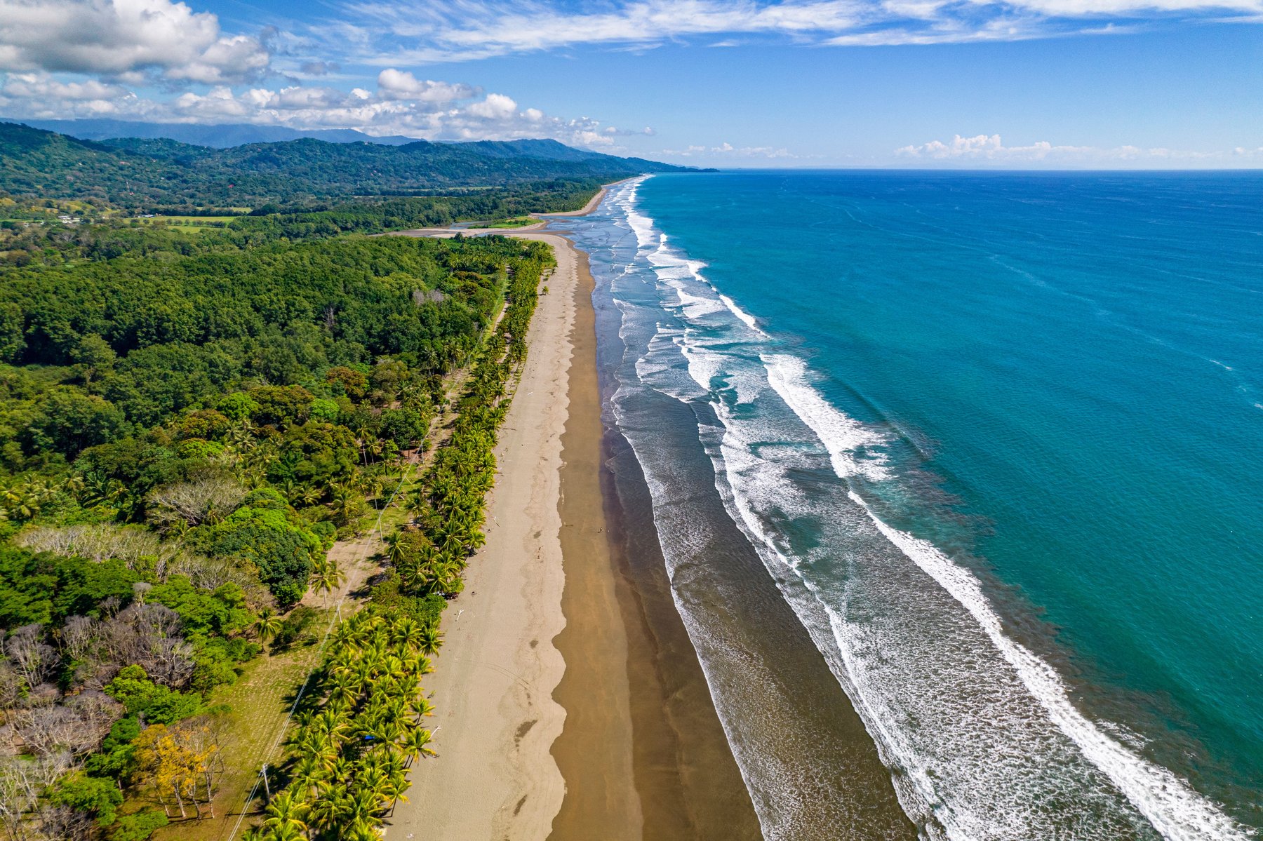 Aerial view of waves rolling into the Costa Rica coastline