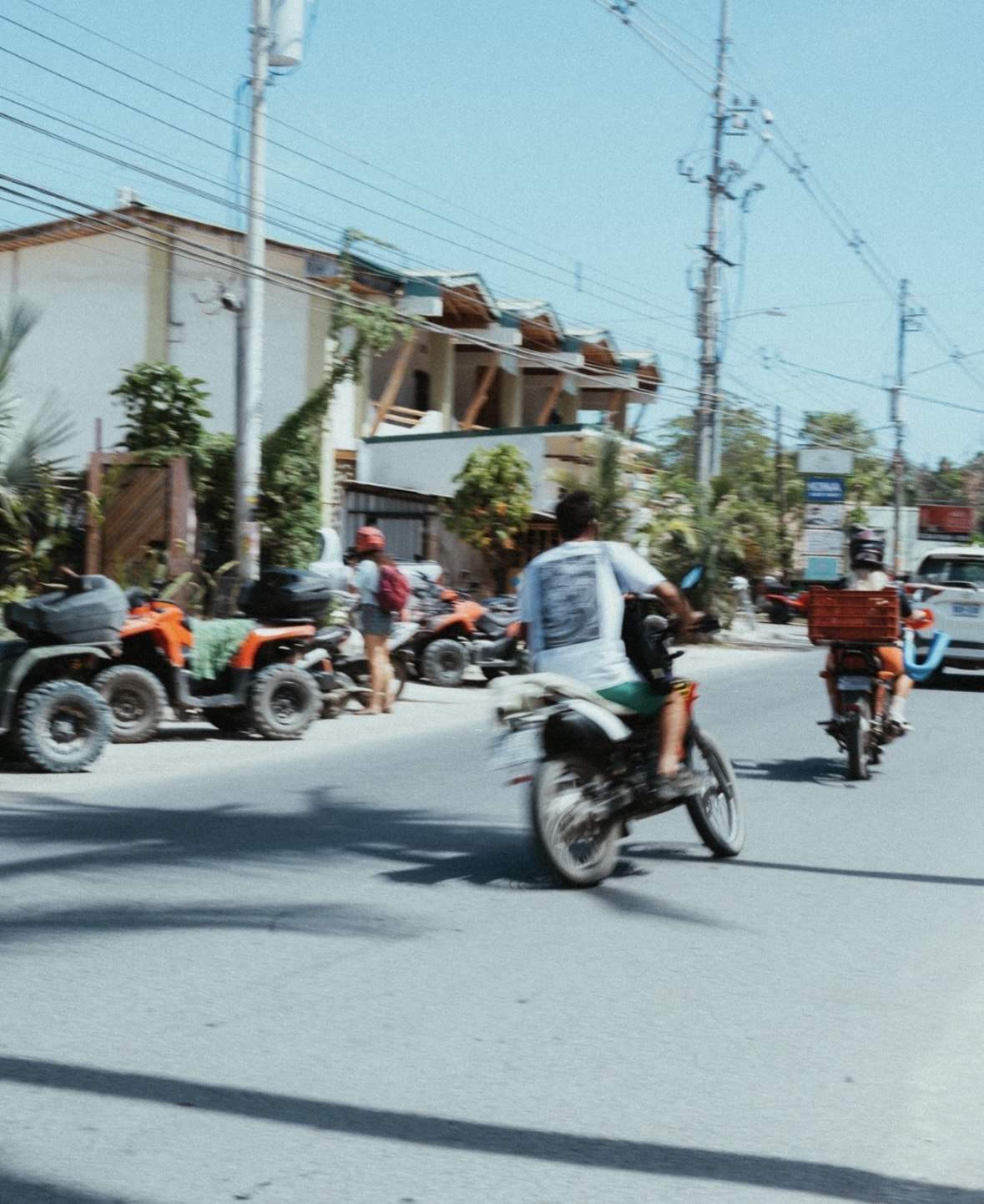 ATVs and motorbikes on a sunny Santa Teresa street
